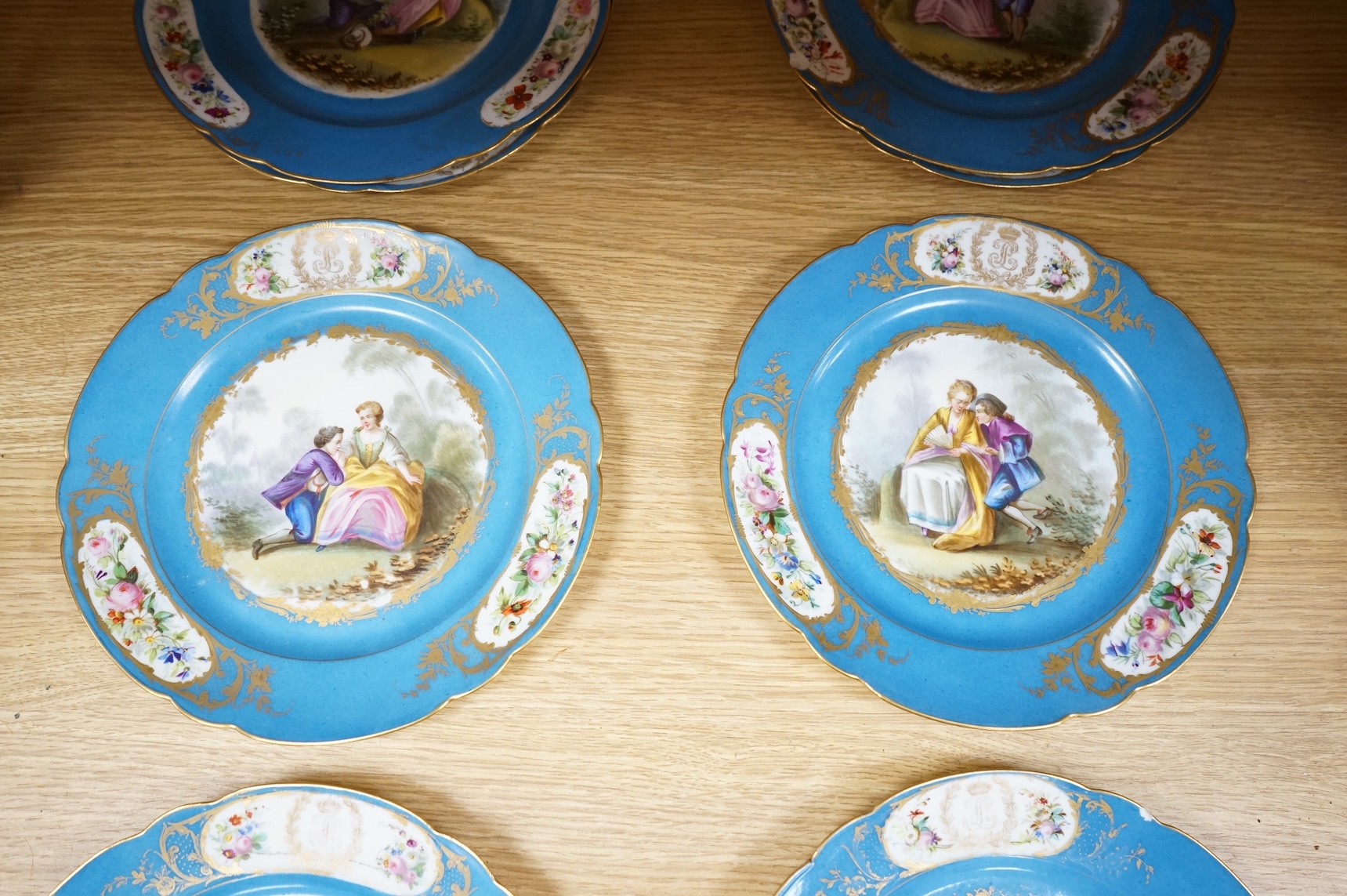A set of eight 19th century Sevres style bleu celeste ground cabinet plates, each painted with a courting couple, 22cm diameter